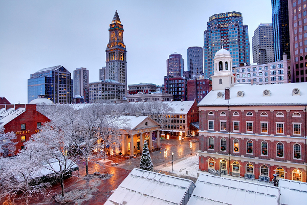Faneuil Hall rooftops covered in snow during the winter season in Boston. Faneuil Hall Also known as Quincy Market is located near the waterfront and Government Center, in Boston, Massachusetts, has been a marketplace and a meeting hall since 1743. Boston is the largest city in New England, the capital of the Commonwealth of Massachusetts