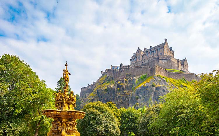 Edinburgh Castle and Gardens, ornate fountain, flower beds and trees.