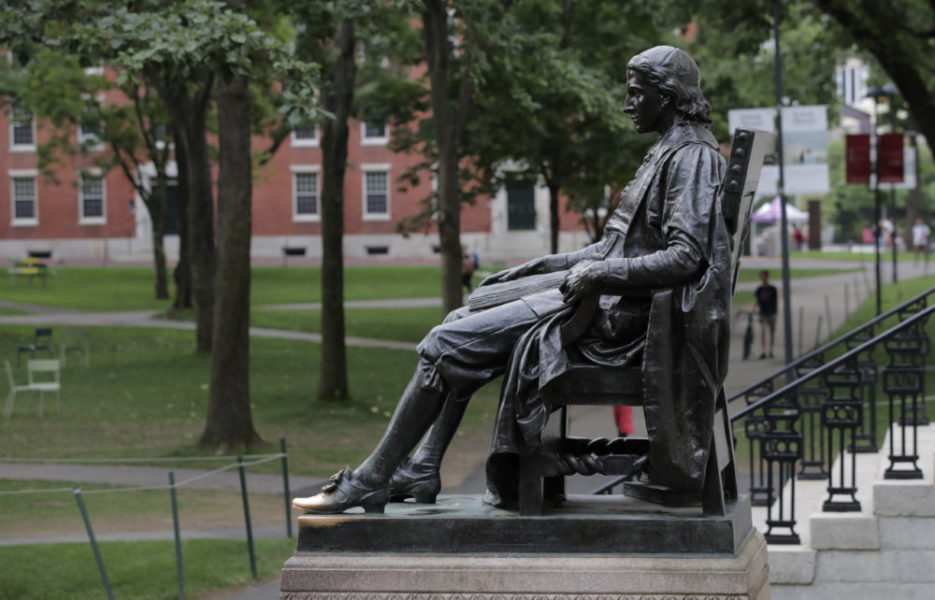 The statue of John Harvard in Harvard Yard at Harvard University in Cambridge, Mass., Tuesday, Aug. 13, 2019. (AP Photo/Charles Krupa)
